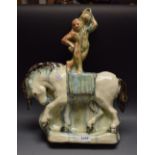 An unusual Art Deco earthenware model of an acrobat standing on horseback,