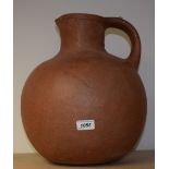 A large terracotta earthenware wine jug, incised banded collar, 36.