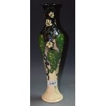 Moorcroft - an elongated baluster vase,