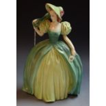 An Austrian earthenware figure of a crinoline lady in green dress and bonnet, 25cm,