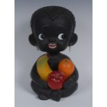 A mid 20th century slip-cast novelty money box, as a black child bearing fruit,