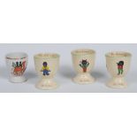 Three Willow Art The Golliwogg egg cups, each printed with gollies in various poses,