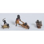 A cold painted bronze, of a young black girl pushing a child in a wheel barrow, 5.