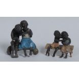 An early 20th century lead figure group, cast as a young black suitor embracing his sweetheart,