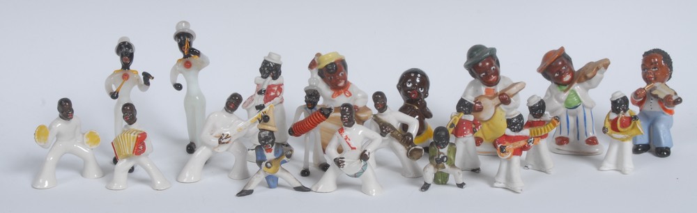 A set of four early 20th century bisque porcelain figures or cake decorations,