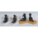 A pair of Art Deco figural bookends, each modelled as a nude black infant, eating a banana,