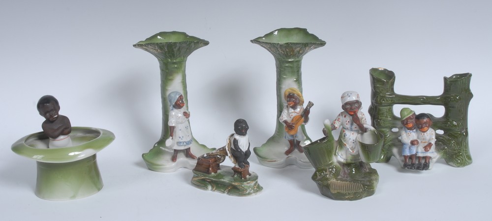 A late 19th century German porcelain figural table vesta, modelled as a black servant girl,