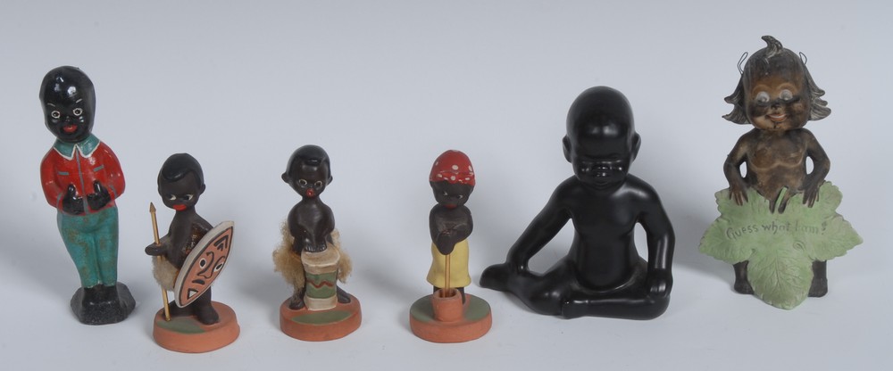 An Art Deco slip-cast figure, of a black baby, seated on the floor,