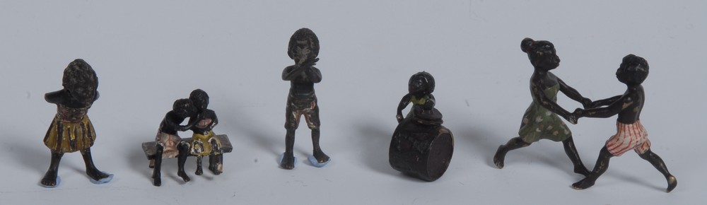 A cold painted bronze group, of a young black girl and boy dancing,