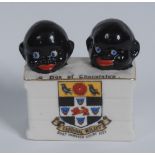 A Willow Crested Ware model, of two black children's heads poking out of a crate,