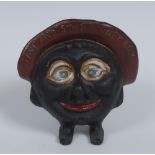 A Chamberlin & Hill cast iron "Save and Smile Money Box", as a large head with wide eyes,