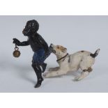 An early 20th century cold painted spelter novelty figure group, cast as a young black boy,