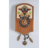 A mid 20th century novelty wall automaton timepiece,