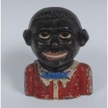 An early 20th century cast iron The Young Ni**er Bank, with painted red jacket and blue bow tie,