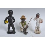 A Continental Art Deco terracotta figure, modelled as a nude black boy, holding a beach ball,