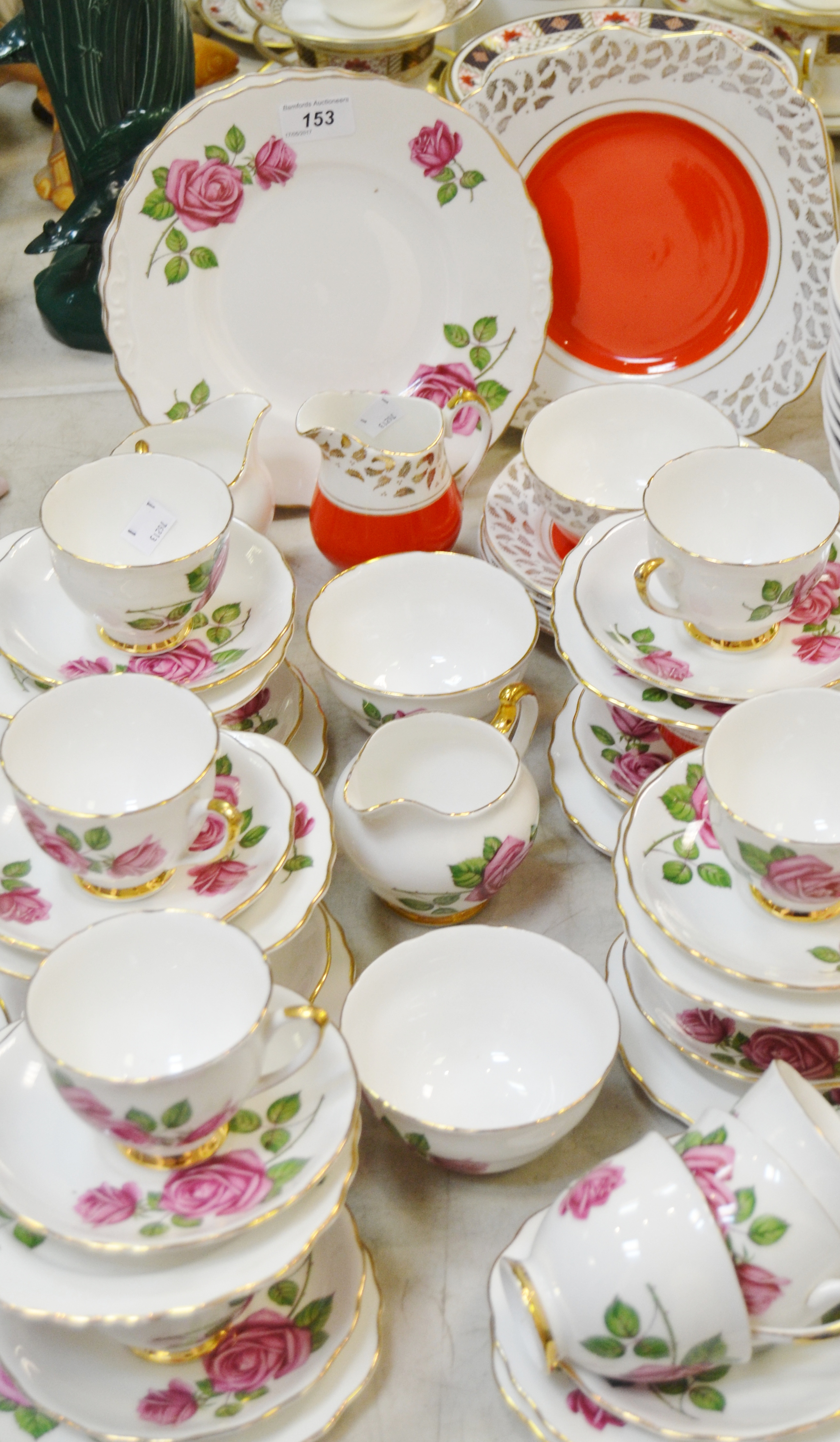 A Crown Regent English Rose tea service, comprising twelve teacups, eleven saucers,