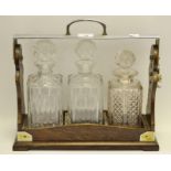 An early 20th century Betjemann's Patent three bottle tantalus,