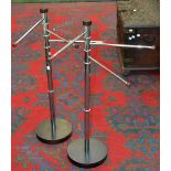 A pair of designer chrome and wood towel stands