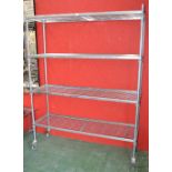 A commercial aluminum moveable four tier shelving unit by Craven Hygienic Storage and Handling.