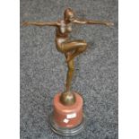 An Art Deco style bronze dancing flapper on rouge marble base