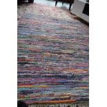 A multi coloured hand knotted rug. 208cm x 154cm.