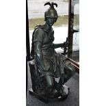 A green patinated cast metal figure of a seated soldier. 127cm high.