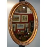 A large oval gilt framed mirror, 88cm,