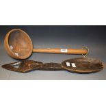 A carved softwood ladle; a carved hardwood tribal wall spoon,