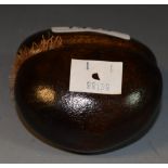 A miniature carving of a Coco De Mer,