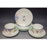 A Shelley part tea set, printed with colourful summer flowers, comprising two tea cups,