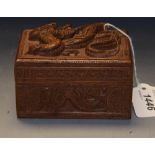 An Indonesian carved harwood trinket box and cover, decorated with dragons in relief, 11cm wide,