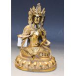 Indonesian School - a gilt bronze model of a deity, sitting cross legged,