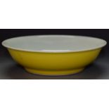 A yellow porcelain Chinese bowl, six character mark to base, the interior with celadon glaze,