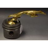 Automobilia - a car mascot, cast as a stylized greyhound, at chase, Porsche piston base, 14cm high,