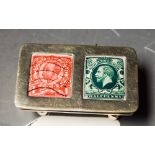 An Edwardian style sterling silver stamp case, cover with enamel panels, resting on four bun feet,