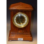 An early 20th century inlaid oak cased mantel clock, arabic dial,