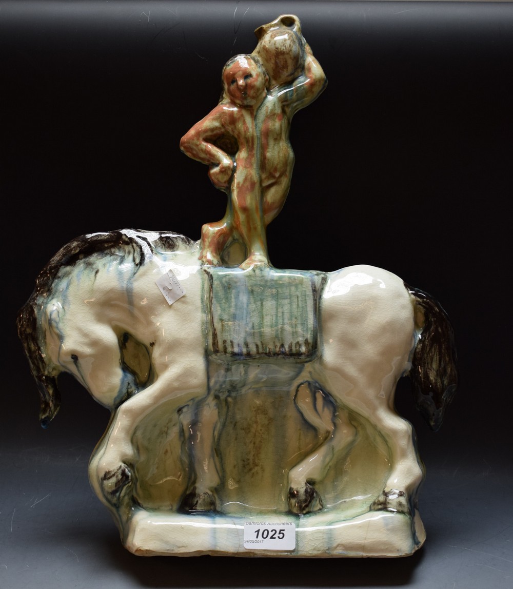 An unusual Art Deco earthenware model of an acrobat standing on horseback,