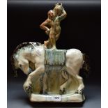 An unusual Art Deco earthenware model of an acrobat standing on horseback,