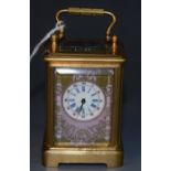 A miniature gilt brass French style carriage clock, the porcelain panels painted with flowers,