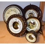 An oak circular wall mounted barometer with carved chain link surround;