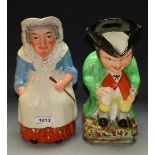 A Staffordshire hunch-back Toby jug; another modelled as Judy,