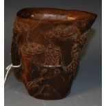 A carved resin libation cup, with figures in a mountainous landscape,