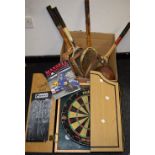 A brown leather lace up football; a Unicorn Phil Taylor dart board and cabinet;