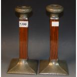 A pair of Art Deco pewter mounted rosewood table candlesticks, of angular form, 23cm,