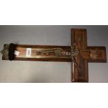 A rosewood crucifix with brass inlay,