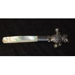 A Victorian style mother of pearl baby's rattle, mounted with a sterling silver owl and bells,