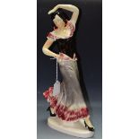 A large continental earthenware model of a Flamenco Dancer, glazed in glossy tones of pink, grey,