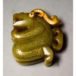 A Chinese style carved jade mythical beast, inlaid with gold coloured metal,