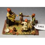 A reproduction Bergman type cold painted metal figure group, musician and dancing children,