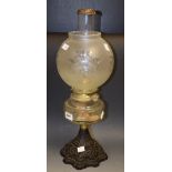 A late 19th Century oil lamp, cast iron base,